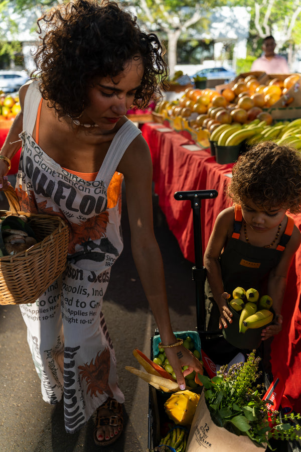 Hannah Chehab teaching her child about fresh herbs and vegetables